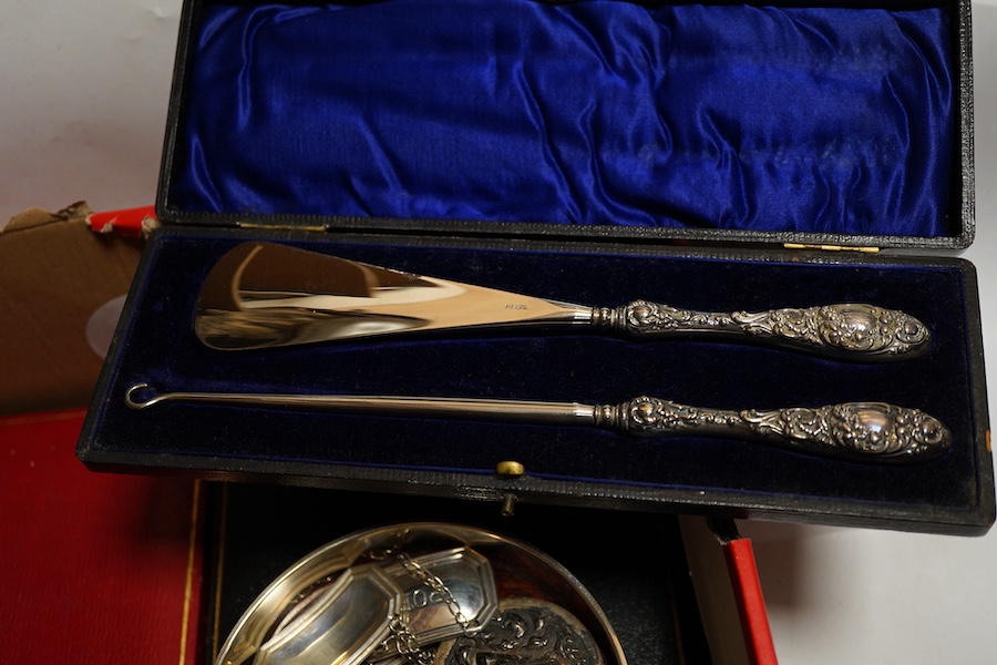 An Elizabeth II silver bottle coaster, London, 1997, M C Hersey & Son Ltd together with a cased set of six bright cut teaspoons, a cased set of pistol grip handled tea knives, a cased silver handled shoe horn and button